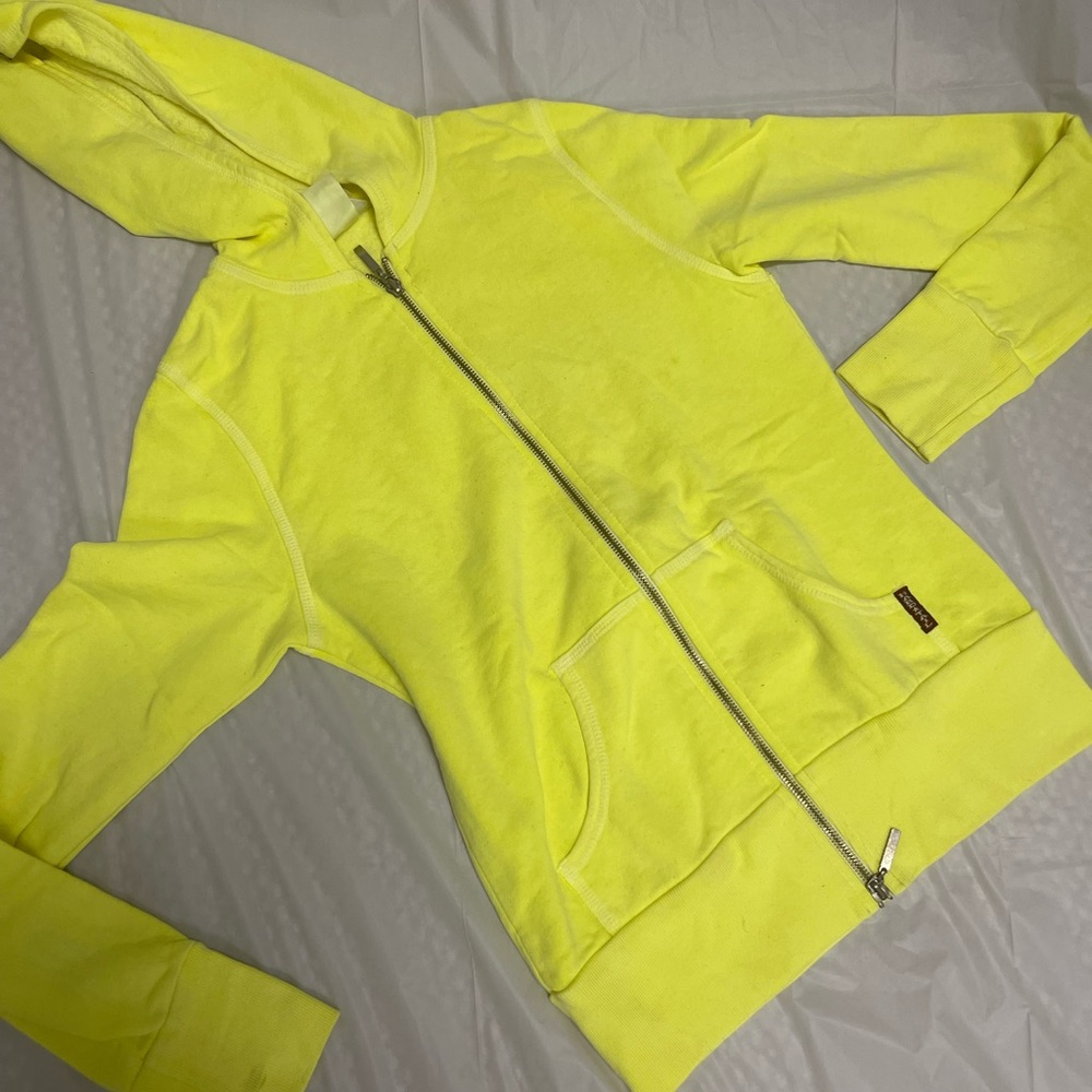 Neon yellow zip up  sweater with a hood and it is a zip up